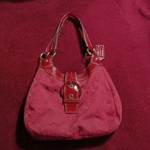 Coach purse red with leather buckle and three pockets with tan liner. Like new.